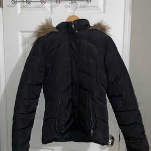 Lightly worn black puffer jacket with faux fur lining on the hood.